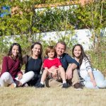 A joyful family enjoying sunny moments in a lush Portuguese garden.